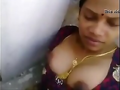 A mature Tamil lady indulges in a steamy session with a younger desi woman, showcasing their sensual skills.